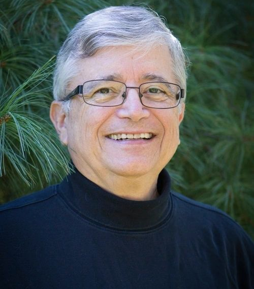 A man with glasses and a black shirt